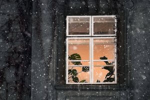 Fenêtre éclairée sous la neige